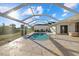 This inviting backyard features a screened-in pool, stone patio, and well-maintained landscaping, perfect for relaxation at 52 Fairway Rd, Rotonda West, FL 33947