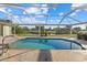 Inviting screened-in pool with a scenic view and stone patio at 52 Fairway Rd, Rotonda West, FL 33947