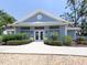 Community clubhouse exterior with landscaping and walkway at 522 Clubside Cir # 10, Venice, FL 34293