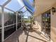 Screened patio with table and chairs and golf course view at 522 Clubside Cir # 10, Venice, FL 34293