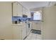 Bright kitchen features white cabinets and appliances at 537 Manatee Ct # 204, Venice, FL 34285
