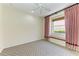 Bright bedroom with a window seat, decorative curtains and patterned carpet at 608 Crane Prairie Way, Osprey, FL 34229