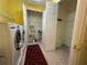 Spacious laundry room with modern washer and dryer adjacent to open storage shelving and tile flooring at 608 Crane Prairie Way, Osprey, FL 34229