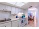 Kitchen with white cabinets, view into dining area, and modern appliances at 612 Bird Bay S Dr # 215, Venice, FL 34285