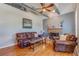 Living room with hardwood floors, leather furniture, and fireplace at 716 Groveland Ave, Venice, FL 34285