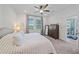 King-size bed, plush bedding, and ample natural light in this main bedroom at 8574 Starlight Loop, Parrish, FL 34219