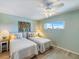 Guest bedroom with twin beds and ceiling fan at 950 Tarpon Center Dr # 202, Venice, FL 34285