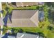 Aerial view of a home with a tile roof, screened lanai, and landscaped backyard at 11897 Hunters Creek Rd, Venice, FL 34293