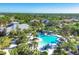 Community pool, clubhouse, and surrounding homes in an aerial view of this vibrant neighborhood at 11897 Hunters Creek Rd, Venice, FL 34293