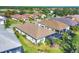 An aerial view of a Florida home with a tile roof, screened-in lanai, and lush landscaping at 11897 Hunters Creek Rd, Venice, FL 34293