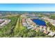 An aerial perspective of a neighborhood with houses, a lake, and trees at 11897 Hunters Creek Rd, Venice, FL 34293