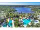 Aerial view of the community pool, lake, and lush green spaces, offering a tranquil setting at 11897 Hunters Creek Rd, Venice, FL 34293