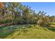 Large backyard with mature trees and plenty of green space at 11897 Hunters Creek Rd, Venice, FL 34293