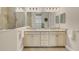 Modern bathroom with double vanity, large mirror, and glass-enclosed shower at 11897 Hunters Creek Rd, Venice, FL 34293