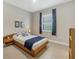 Cozy bedroom with wooden bedframe, simple decor, and ample natural light at 11897 Hunters Creek Rd, Venice, FL 34293