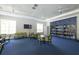 Clubhouse library area with bookshelves, seating area, and a TV at 11897 Hunters Creek Rd, Venice, FL 34293