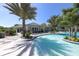 Inviting community pool with a clubhouse and palm trees at 11897 Hunters Creek Rd, Venice, FL 34293