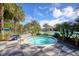 Relaxing hot tub with checkered tile patio and lush landscaping at 11897 Hunters Creek Rd, Venice, FL 34293