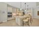 Modern kitchen with white cabinets, stainless steel appliances, and large island at 11897 Hunters Creek Rd, Venice, FL 34293