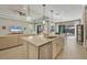 Open-concept kitchen and living area with large island and stainless steel appliances at 11897 Hunters Creek Rd, Venice, FL 34293