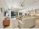 Spacious living room with view of the pool through sliding glass doors at 11897 Hunters Creek Rd, Venice, FL 34293