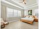 Spacious main bedroom with ample natural light, ceiling fan, and wooden bedframe at 11897 Hunters Creek Rd, Venice, FL 34293