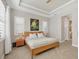 Inviting main bedroom with a wooden bedframe, ceiling fan, and ensuite bathroom at 11897 Hunters Creek Rd, Venice, FL 34293