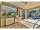 Luxurious outdoor kitchen and screened lanai overlooking pool and lush greenery at 11897 Hunters Creek Rd, Venice, FL 34293