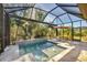 Sparkling pool with a water feature and ample space for lounging at 11897 Hunters Creek Rd, Venice, FL 34293