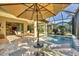 Inviting pool area with lounge chairs and covered seating at 11897 Hunters Creek Rd, Venice, FL 34293