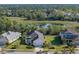 Bird's-eye view of a house and neighborhood with a pond at 12115 Stuart Dr, Venice, FL 34293