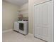 Laundry room with washer, dryer, shelving and a storage closet at 12115 Stuart Dr, Venice, FL 34293