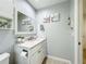 Bathroom with white vanity, a large mirror, and tile flooring at 124 Villa Dr # 124, Osprey, FL 34229