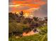 Stunning sunset over the calm waters of a canal at 124 Villa Dr # 124, Osprey, FL 34229