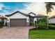 Attractive single-story home with brown garage door and landscaped yard at 13016 Rinella St, Venice, FL 34293