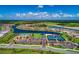 Aerial view of community with lake, pool, tennis courts, and clubhouse at 13307 Pacchio St, Venice, FL 34293