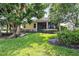 Landscaped backyard with lush greenery and spacious lawn at 134 Savona Way, North Venice, FL 34275
