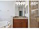 Bathroom with granite vanity, mirror, and shower at 134 Savona Way, North Venice, FL 34275