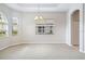 Spacious dining room with neutral decor and a light fixture at 134 Savona Way, North Venice, FL 34275