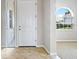 Bright entryway with a white door and tiled floor at 134 Savona Way, North Venice, FL 34275