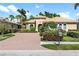Attractive single-story home with a brick driveway and lush landscaping at 134 Savona Way, North Venice, FL 34275