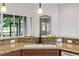 Granite countertop kitchen island with sink and breakfast bar at 134 Savona Way, North Venice, FL 34275