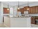 Spacious kitchen with granite countertops, wood cabinets, and stainless steel appliances at 134 Savona Way, North Venice, FL 34275