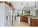 White appliances and wood cabinets in this eat-in kitchen at 134 Savona Way, North Venice, FL 34275