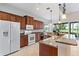 Kitchen features granite island, breakfast bar, and view to backyard at 134 Savona Way, North Venice, FL 34275