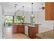 Kitchen with wood cabinets, granite counters and island at 134 Savona Way, North Venice, FL 34275