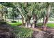 Mature landscaping with palm trees and manicured hedges at 134 Savona Way, North Venice, FL 34275