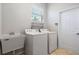 Laundry room with washer, dryer, and utility sink at 134 Savona Way, North Venice, FL 34275