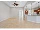 Bright living room with tile floors and views into kitchen at 134 Savona Way, North Venice, FL 34275