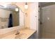 Bathroom with single sink vanity, large mirror, and shower/tub at 149 S Port Dr, Venice, FL 34285